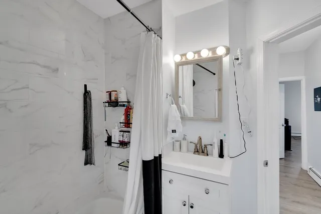 a bathroom with a bathtub sink a mirror and shower