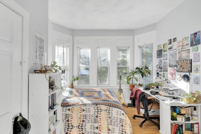 a bedroom with furniture and a potted plant