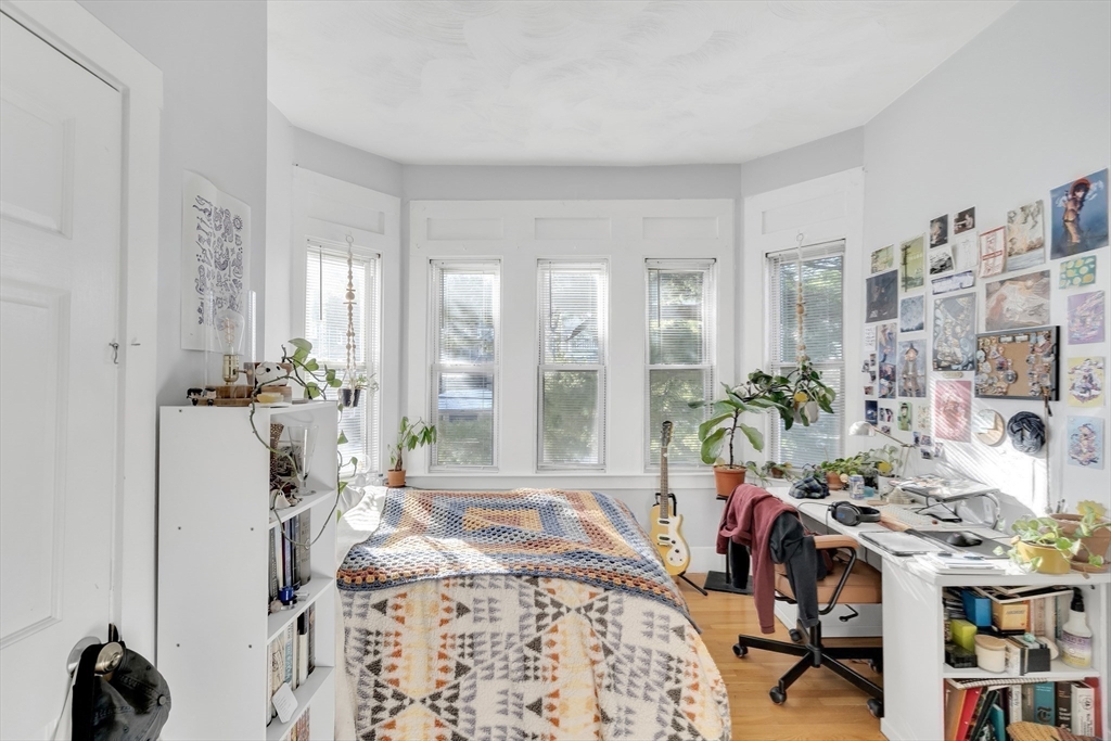 39 Union Street Boston, MA 02135 - Photo 10 of 27 a bedroom with furniture and a potted plant