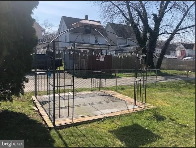 a view of a park with iron fence