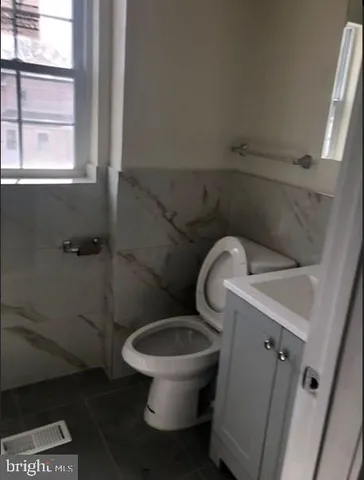 a white toilet sitting next to a window