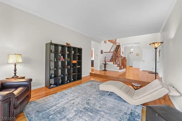 a living room with furniture a lamp and a bookshelf