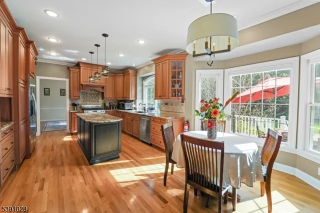 a dining room with furniture a chandelier and wooden floor