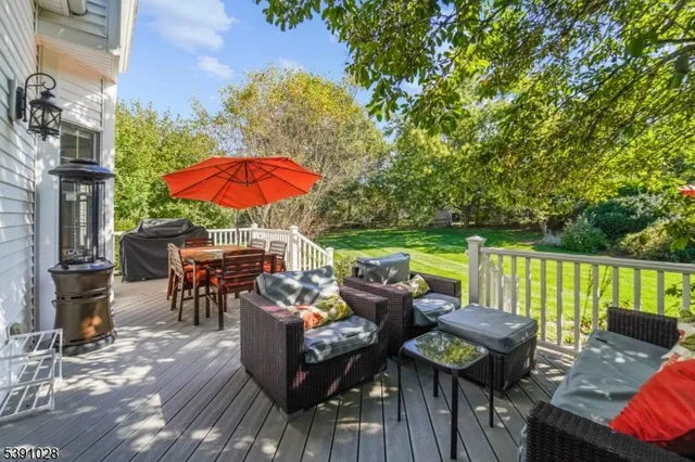 an outdoor sitting area with furniture and wooden floor