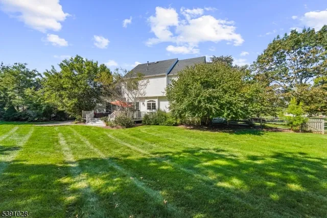 a view of a big yard with a house in the background