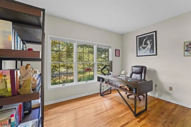 a work room with furniture and a floor to ceiling window