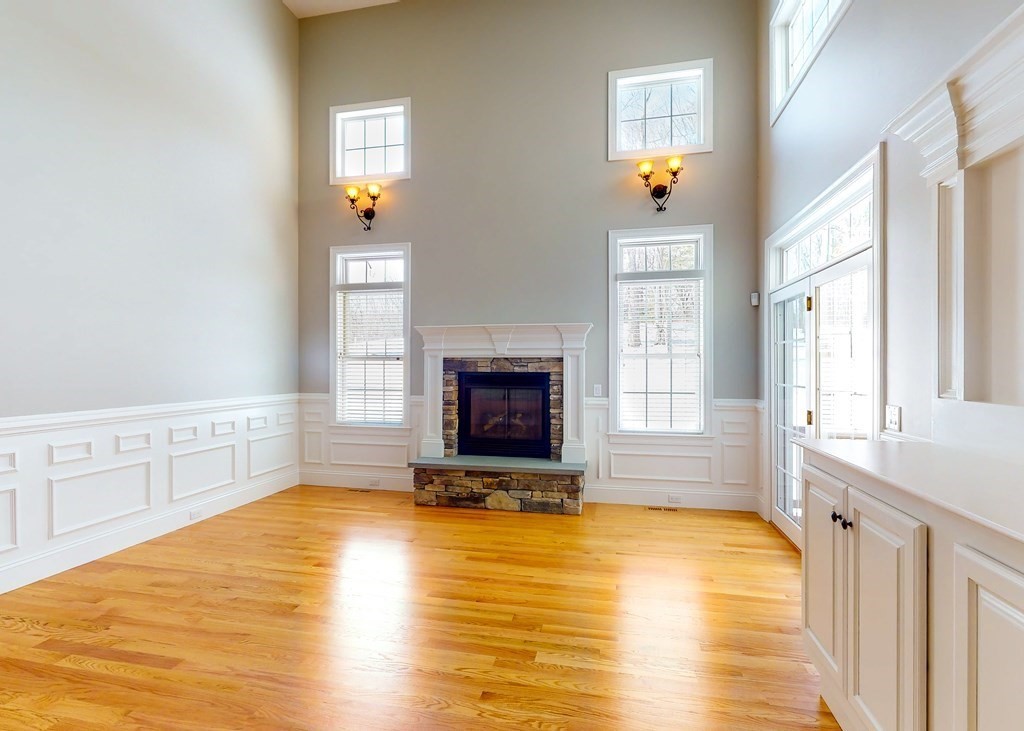 80 Clubhouse Way, Unit 80 Sutton, MA 01590 - Photo 11 of 29 a view of a livingroom with wooden floor and a fireplace