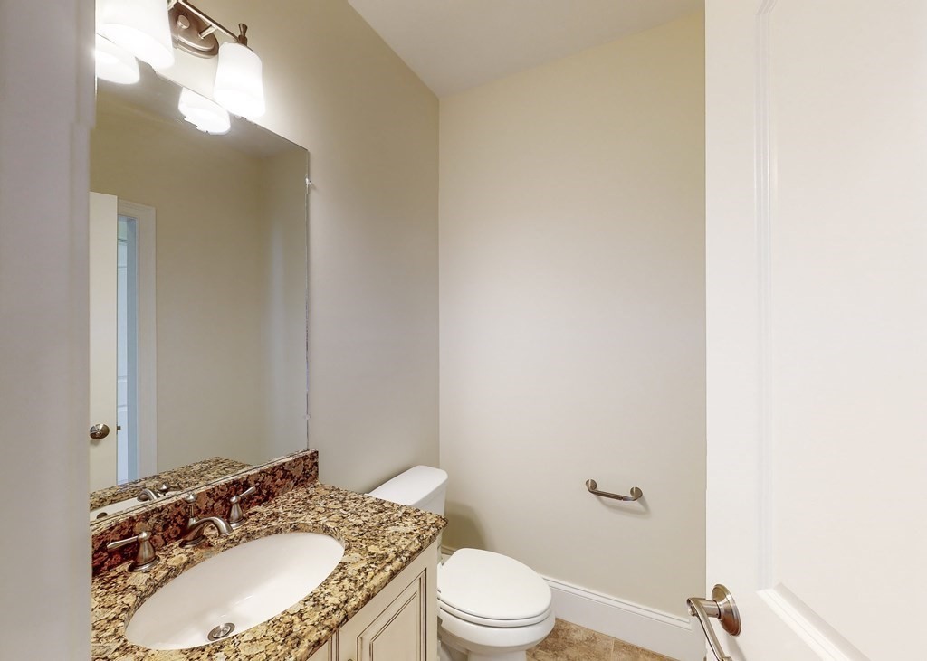 80 Clubhouse Way, Unit 80 Sutton, MA 01590 - Photo 13 of 29 a bathroom with a granite countertop sink and a mirror