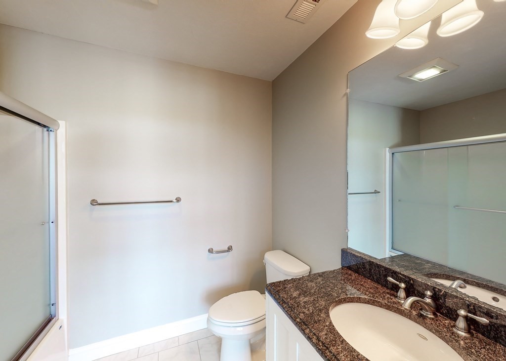 80 Clubhouse Way, Unit 80 Sutton, MA 01590 - Photo 18 of 29 a bathroom with a granite countertop sink mirror vanity and toilet