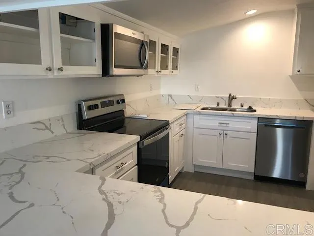a kitchen with a sink stove and microwave
