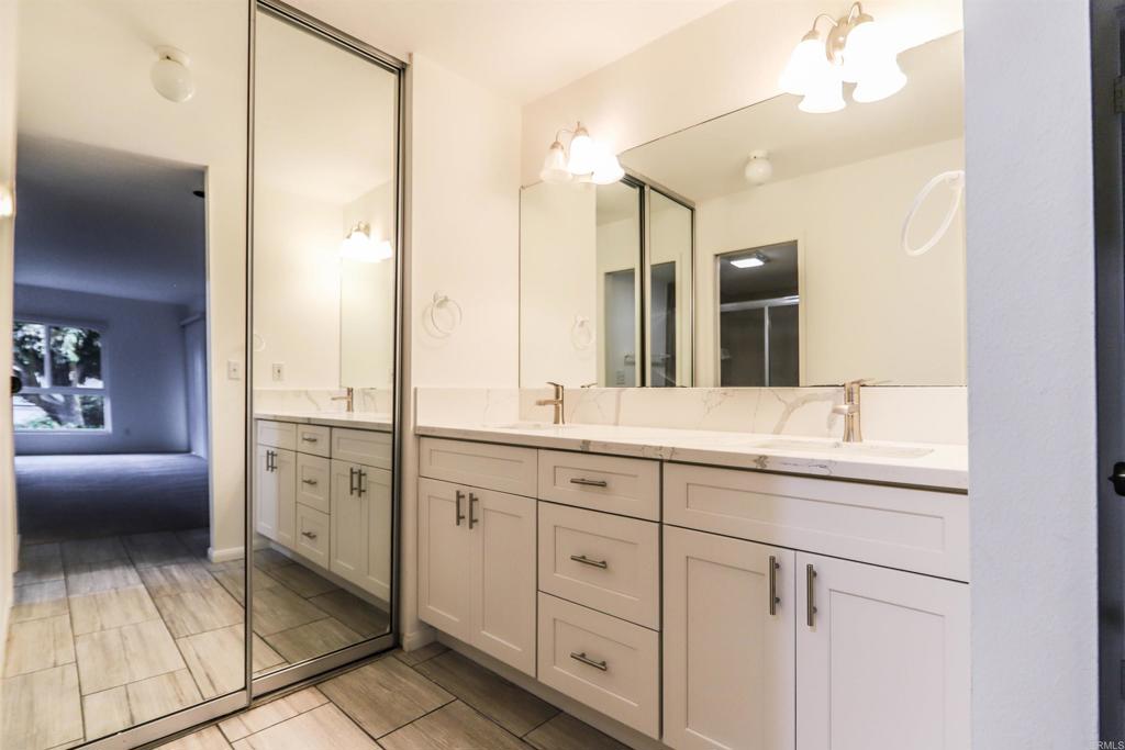 527 South Sierra Avenue, Unit 185 Solana Beach, CA 92075 - Photo 14 of 30 a bathroom with a granite countertop sink mirror and double