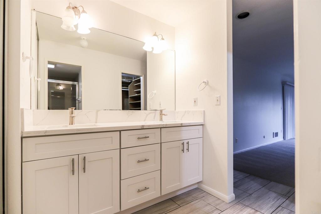 527 South Sierra Avenue, Unit 185 Solana Beach, CA 92075 - Photo 15 of 30 a bathroom with a sink and a mirror