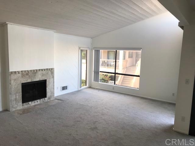 527 South Sierra Avenue, Unit 185 Solana Beach, CA 92075 - Photo 7 of 30 a view of an empty room with a fireplace and a window