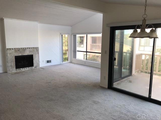 527 South Sierra Avenue, Unit 185 Solana Beach, CA 92075 - Photo 8 of 30 a view of an empty room with a fireplace and a window