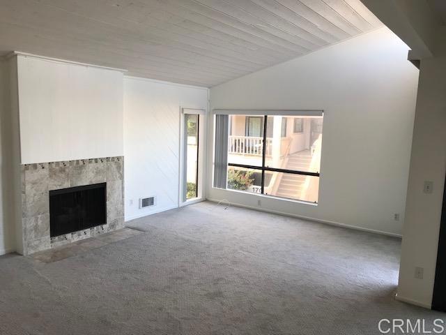 527 South Sierra Avenue, Unit 185 Solana Beach, CA 92075 - Photo 9 of 30 a view of an empty room with a fireplace and a window