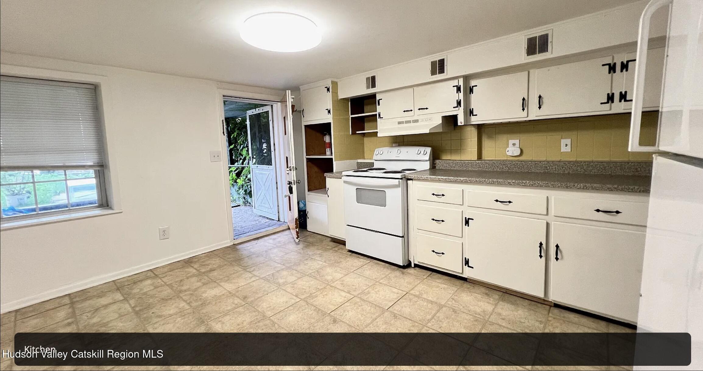 602 Columbia Street, Unit 1 Hudson, NY 12534 - Photo 13 of 19 a kitchen with stainless steel appliances granite countertop a stove a sink and white cabinets