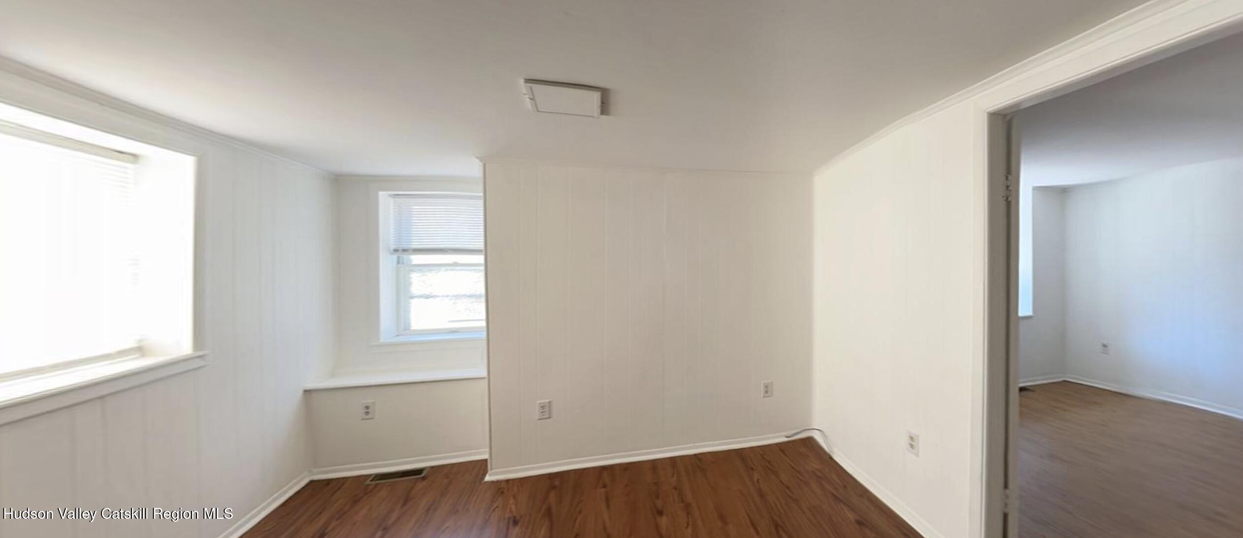602 Columbia Street, Unit 1 Hudson, NY 12534 - Photo 5 of 19 a view of an empty room with wooden floor and a window