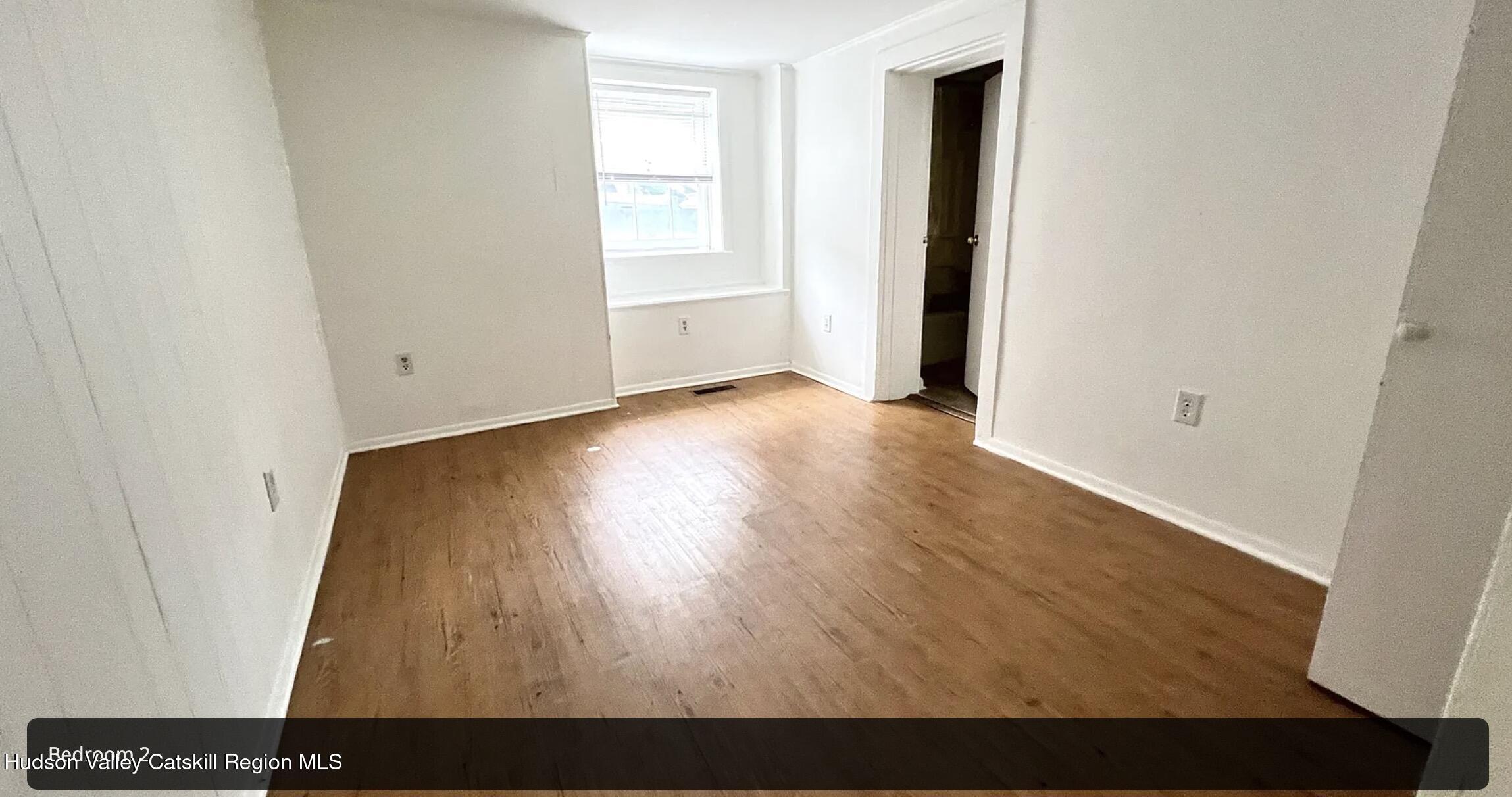 602 Columbia Street, Unit 1 Hudson, NY 12534 - Photo 9 of 19 an empty room with wooden floor and closet