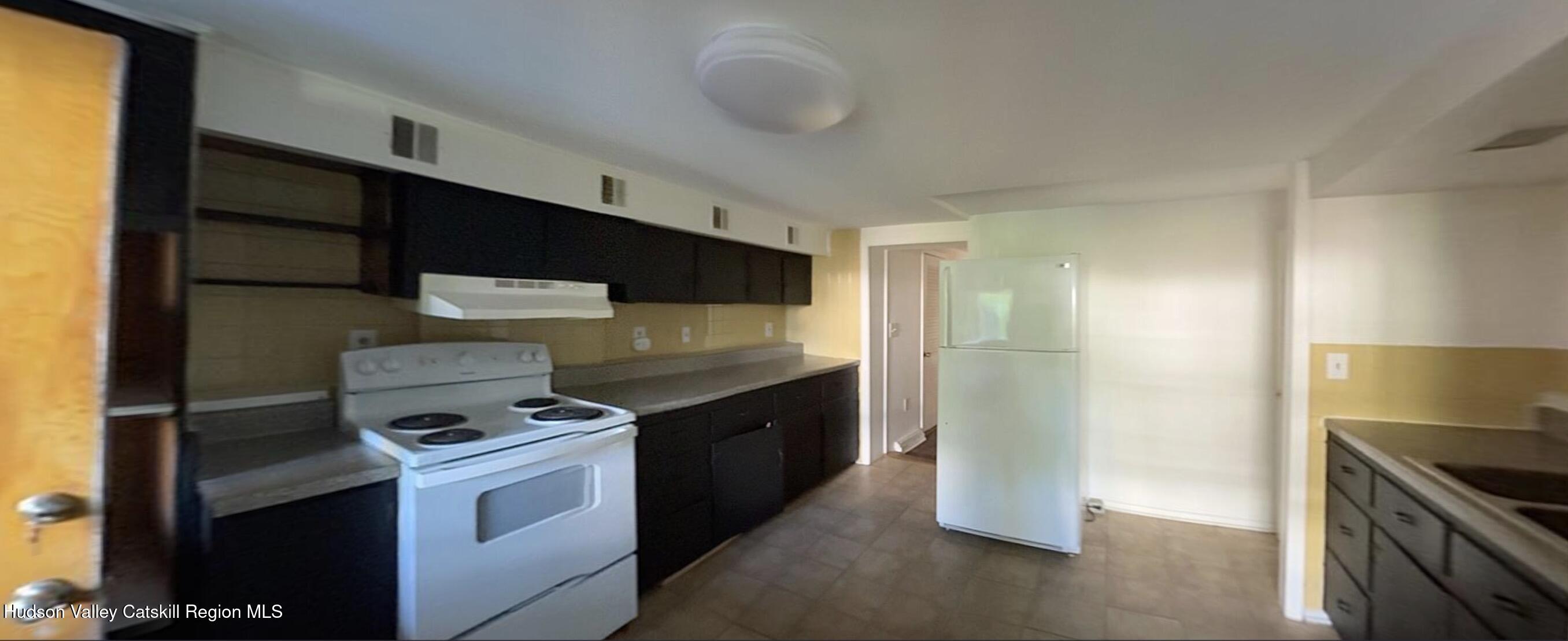 602 Columbia Street, Unit 1 Hudson, NY 12534 - Photo 10 of 19 a kitchen with stainless steel appliances granite countertop a stove and a refrigerator