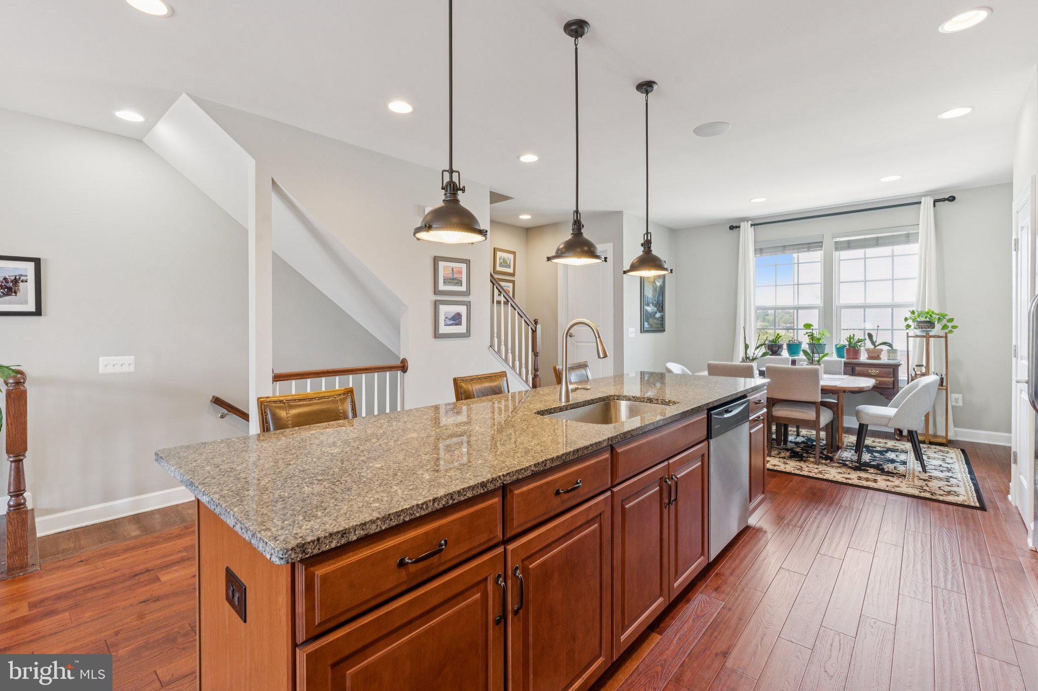 9924 Whitemoss Drive Manassas, VA 20109 - Photo 10 of 43 a kitchen with center island a sink appliances and wooden floor