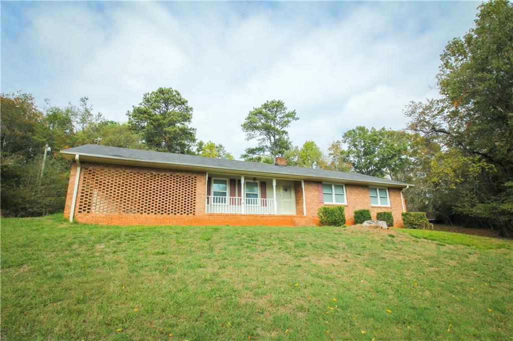 4732 Browns Bridge Road Gainesville, GA 30504 - Photo 1 of 1 a front view of house with yard and trees all around