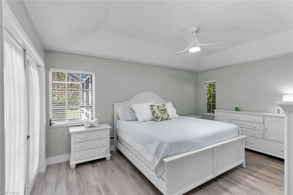 789 Coldstream Court Naples, FL 34104 - Photo 14 of 26 a bedroom with a bed and a large window