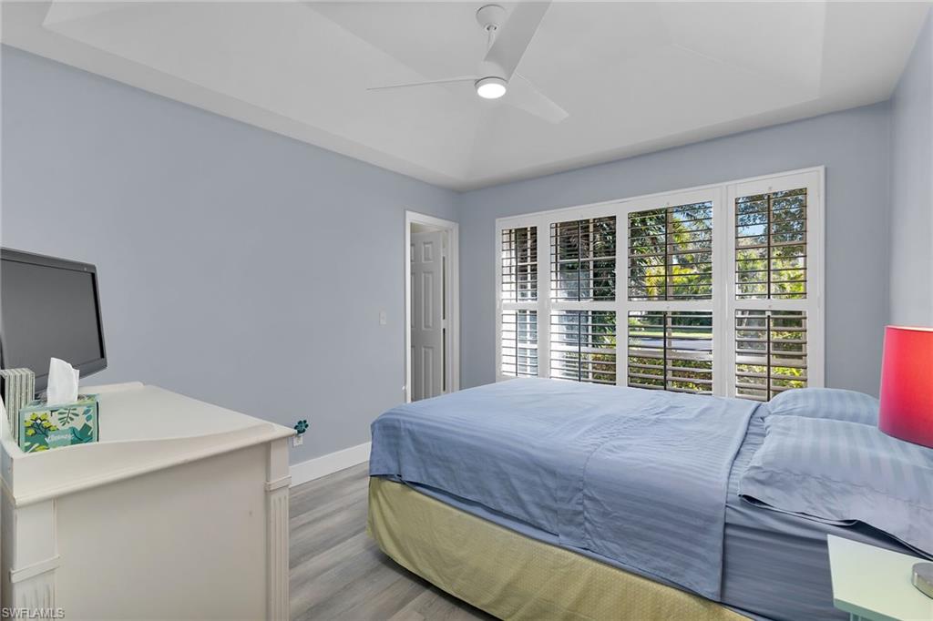 789 Coldstream Court Naples, FL 34104 - Photo 19 of 26 a bedroom with a large bed and a window