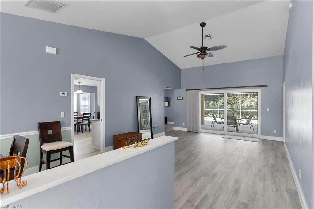789 Coldstream Court Naples, FL 34104 - Photo 2 of 26 a living room with furniture large window and wooden floor