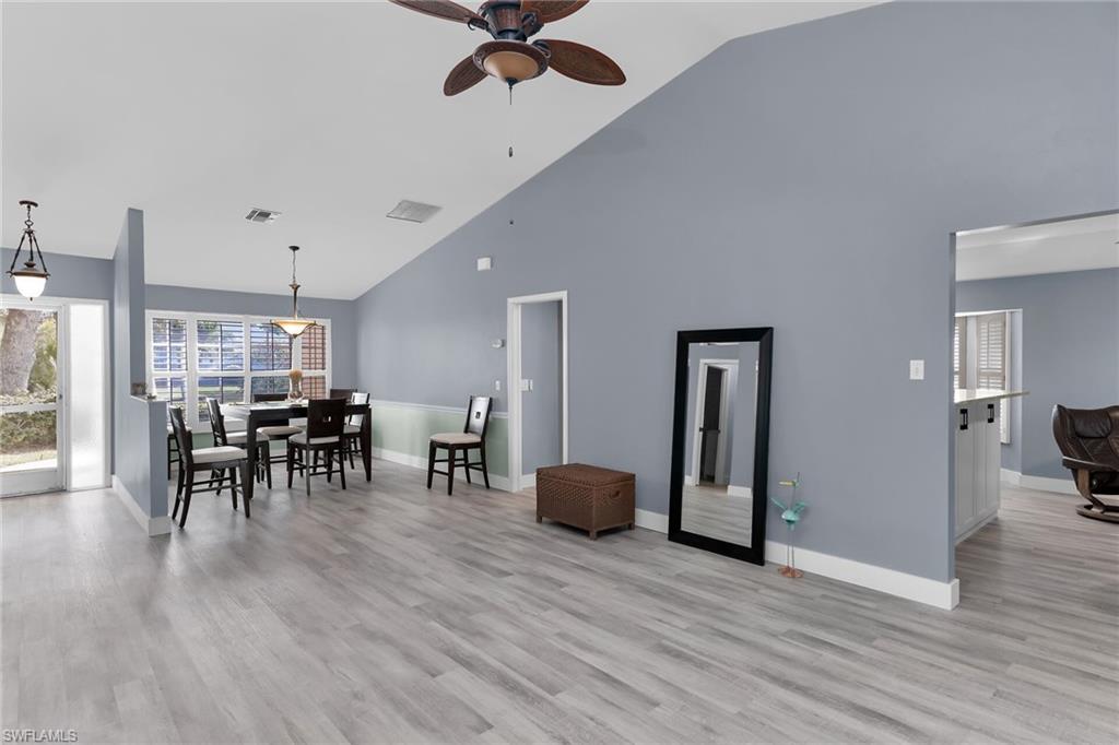 789 Coldstream Court Naples, FL 34104 - Photo 3 of 26 a view of a room with furniture and wooden floor