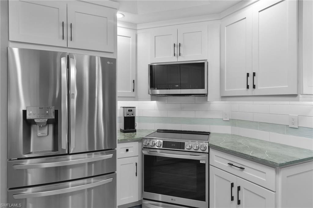 789 Coldstream Court Naples, FL 34104 - Photo 9 of 26 a kitchen with cabinets stainless steel appliances and a counter space