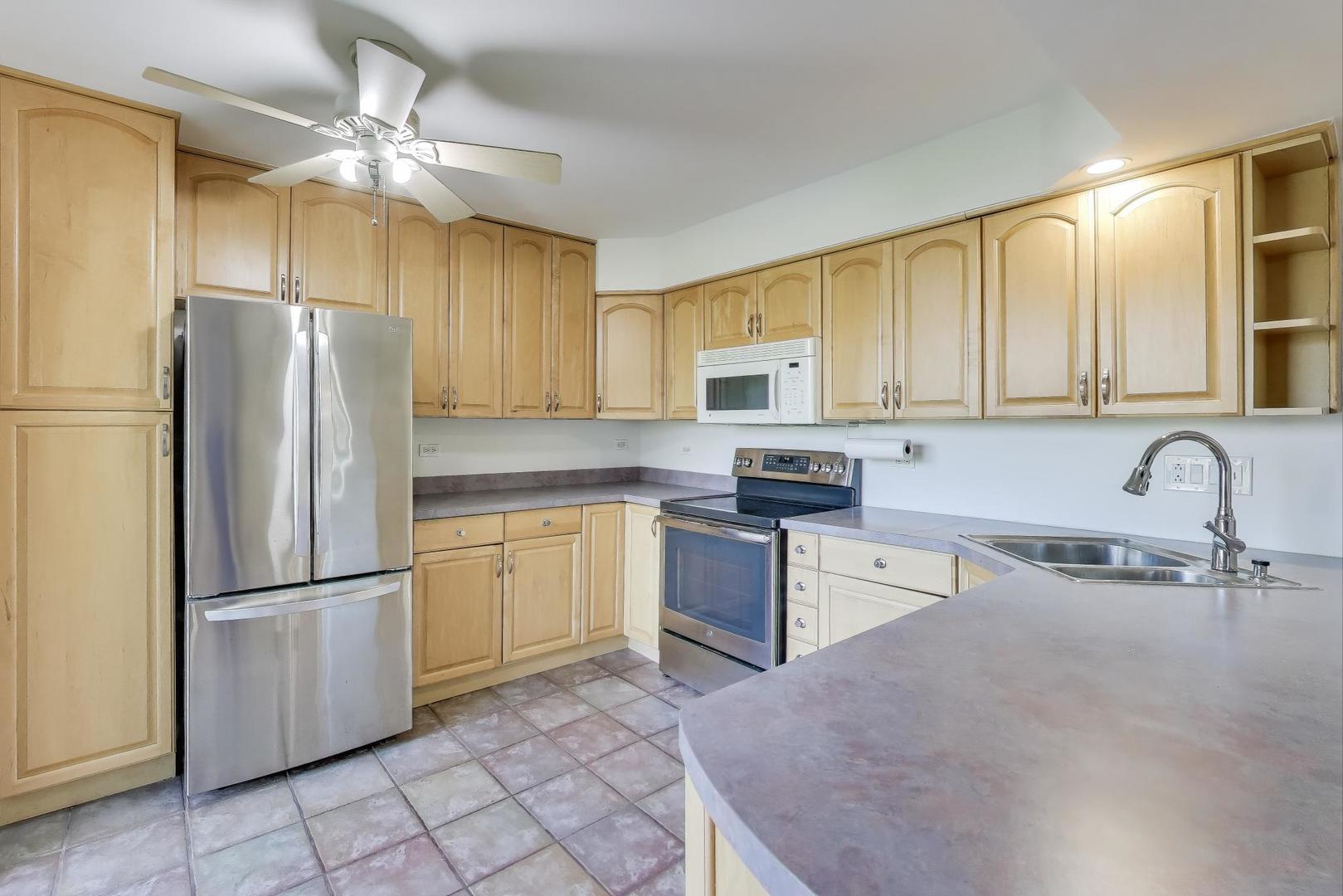 740 Chandler Road Gurnee, IL 60031 - Photo 6 of 26 a kitchen with stainless steel appliances granite countertop a refrigerator sink and cabinets