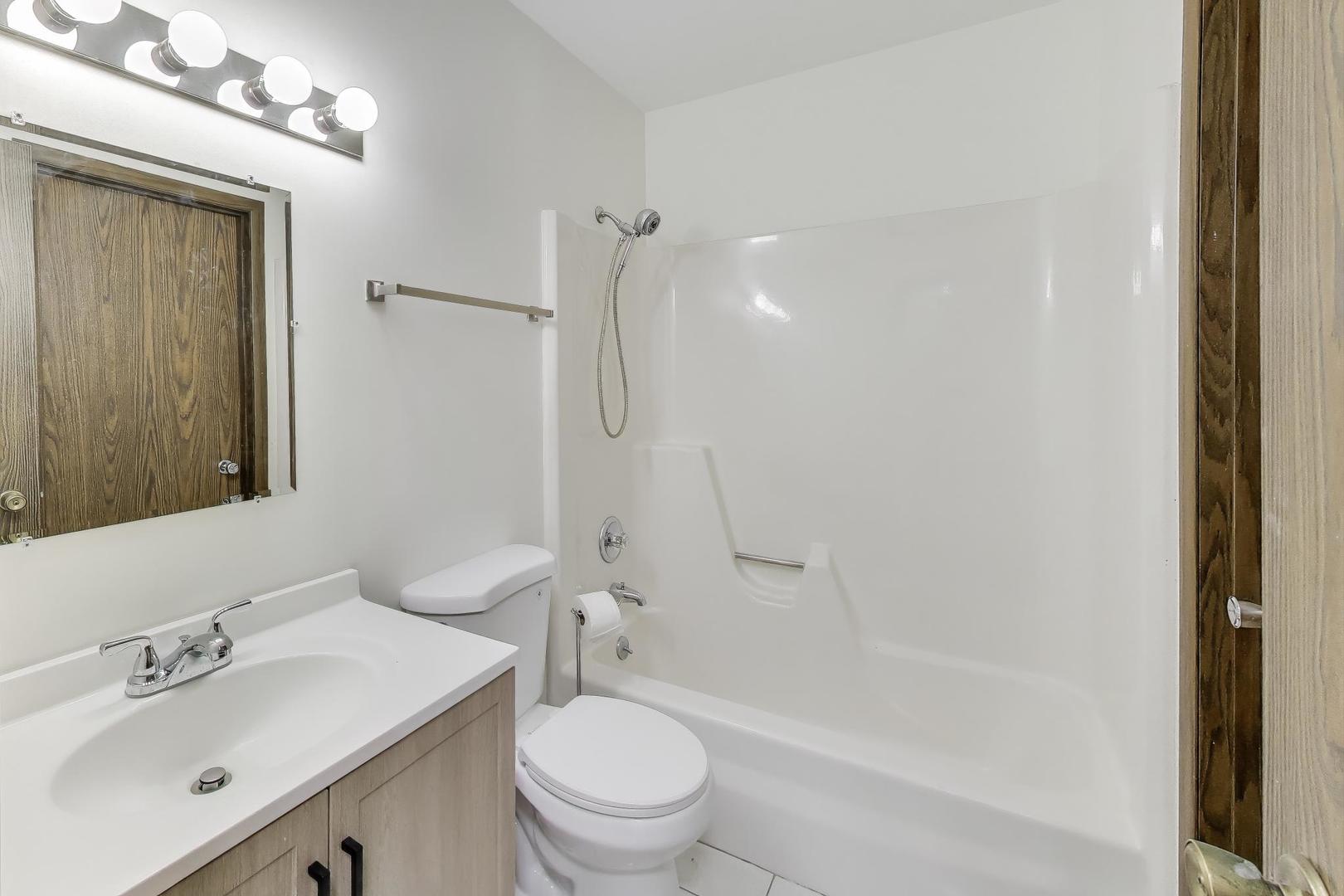 740 Chandler Road Gurnee, IL 60031 - Photo 10 of 26 a bathroom with a sink toilet and shower