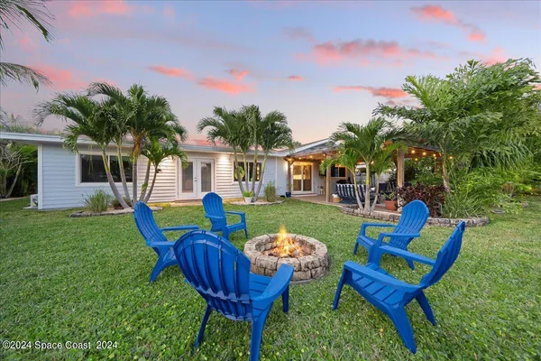 a view of a house with backyard porch and sitting area