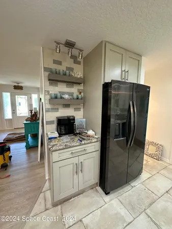 a kitchen with a stove and a refrigerator
