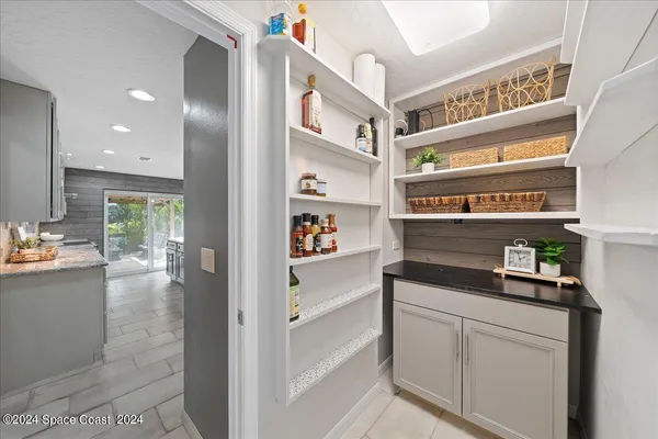 a kitchen with stainless steel appliances granite countertop a lot of cabinets and wooden floor