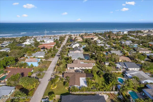 an aerial view of residential building and ocean