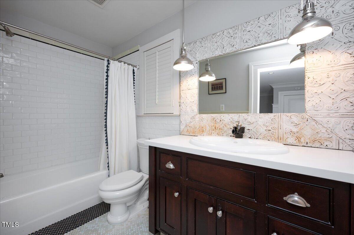 2412 Beechridge Road Raleigh, NC 27608 - Photo 14 of 39 a bathroom with a granite countertop sink toilet and shower