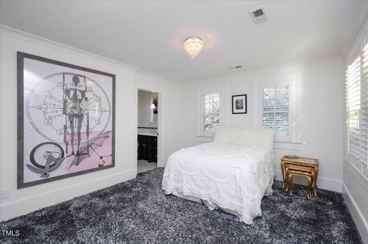 2412 Beechridge Road Raleigh, NC 27608 - Photo 15 of 39 a bedroom with a bed and a wall painting