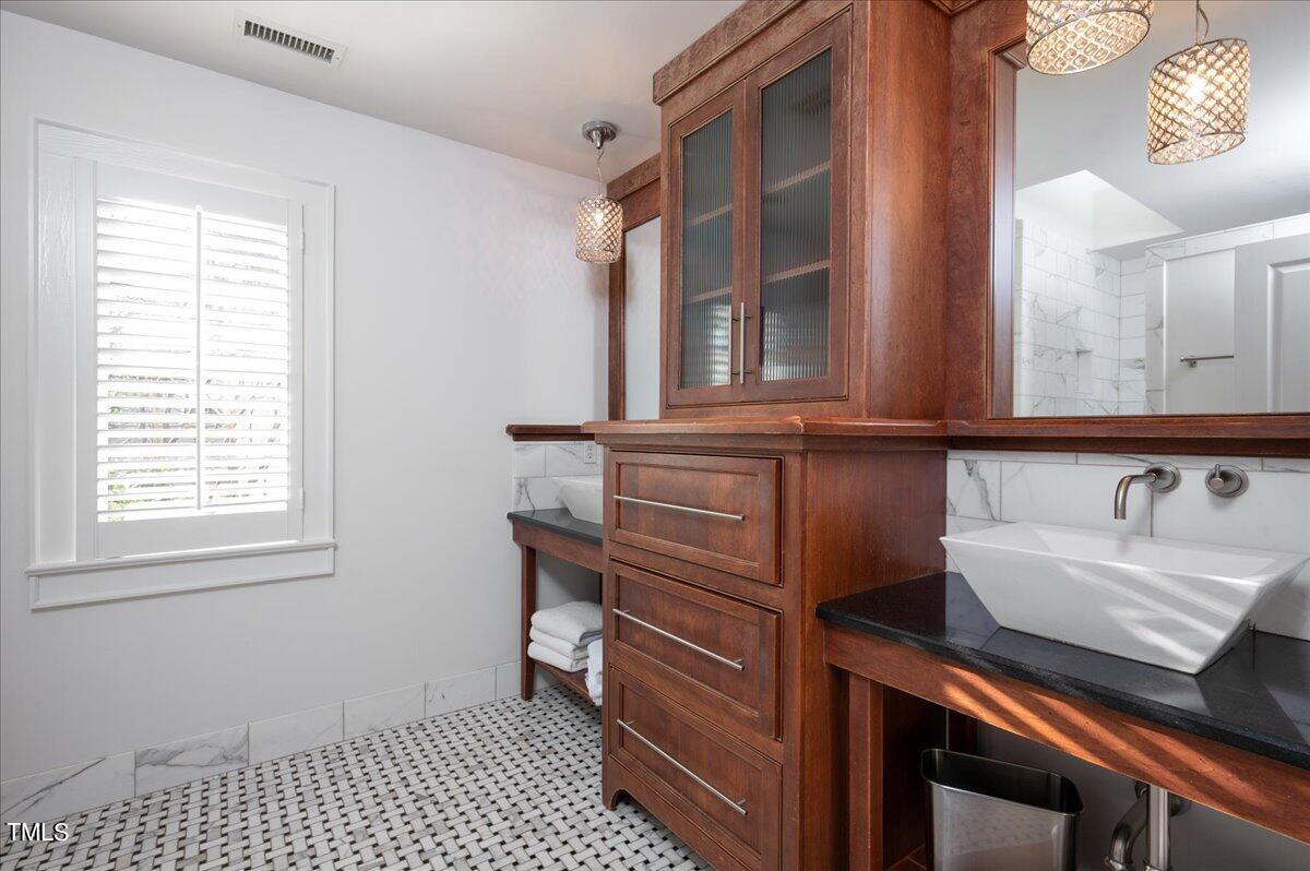 2412 Beechridge Road Raleigh, NC 27608 - Photo 19 of 39 a bathroom with a sink and a mirror