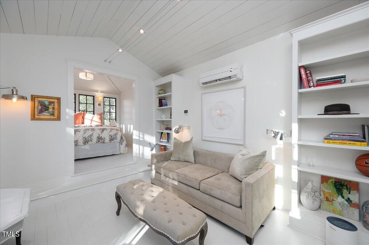 2412 Beechridge Road Raleigh, NC 27608 - Photo 24 of 39 a living room with furniture and a cabinet