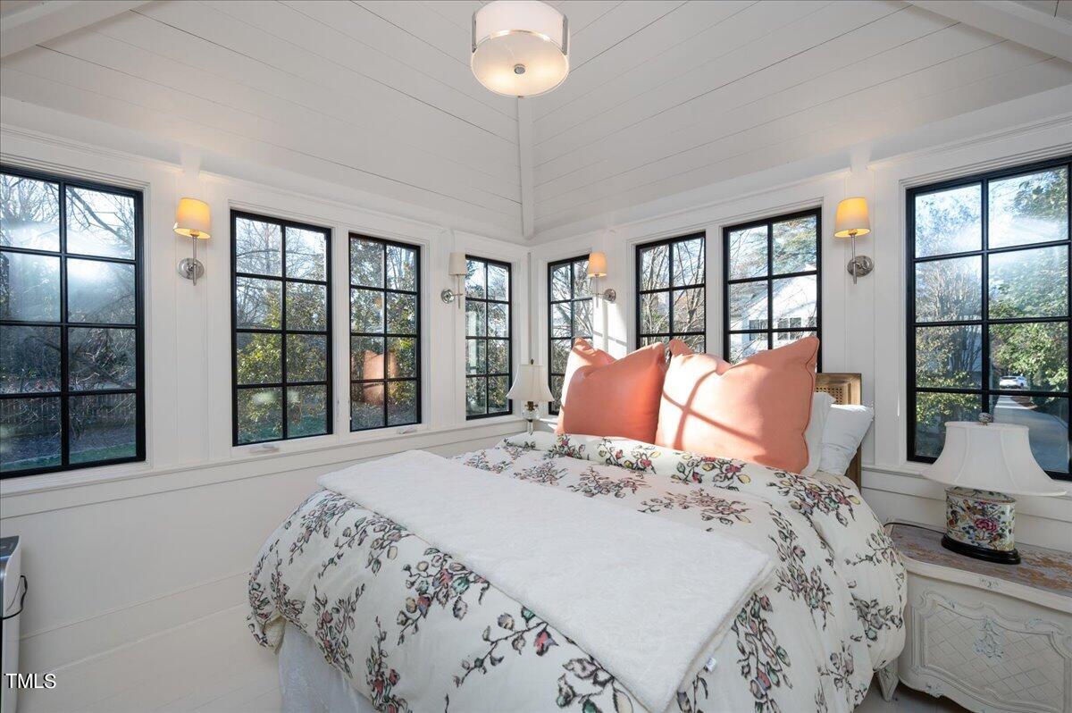 2412 Beechridge Road Raleigh, NC 27608 - Photo 26 of 39 a bedroom with a large bed and a large window