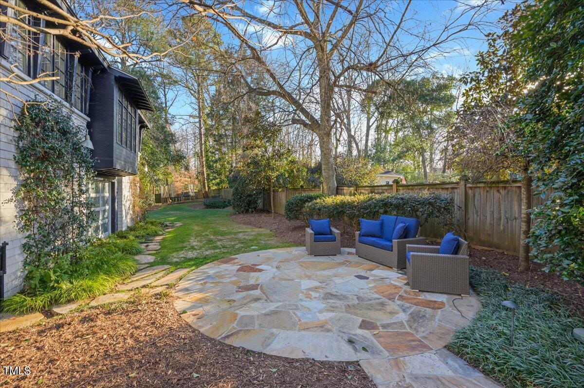 2412 Beechridge Road Raleigh, NC 27608 - Photo 35 of 39 a view of backyard with outdoor seating and trees