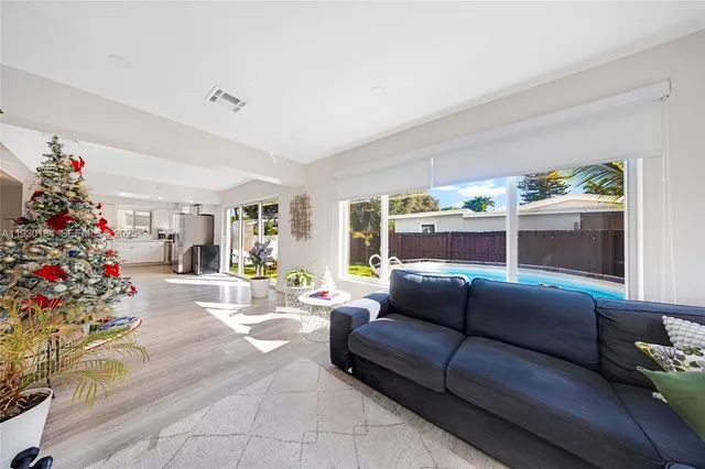 a living room with furniture and flowers