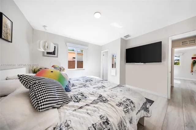 a bedroom with a bed and a window