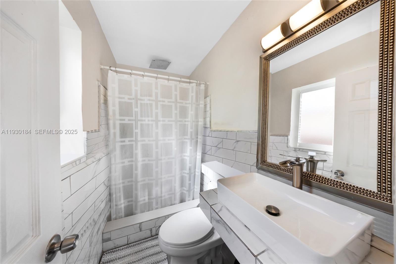 907 North Park Road Hollywood, FL 33021 - Photo 19 of 34 a bathroom with a sink a toilet and shower