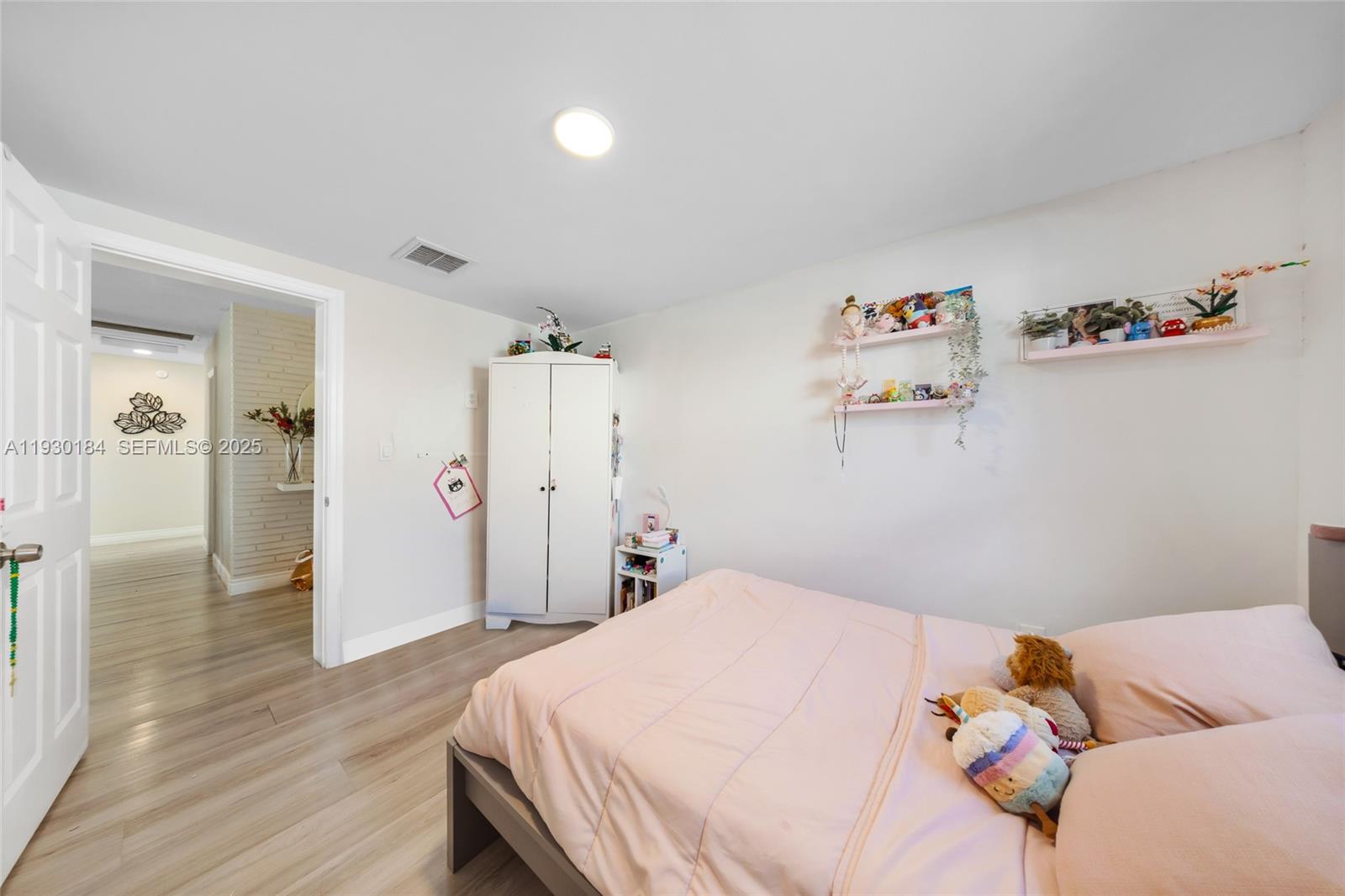 907 North Park Road Hollywood, FL 33021 - Photo 28 of 34 a bedroom with a bed and wooden floor