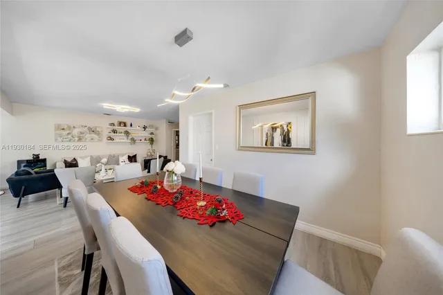 a view of a dining room with furniture and wooden floor