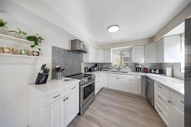 a kitchen with a white cabinets stove and sink