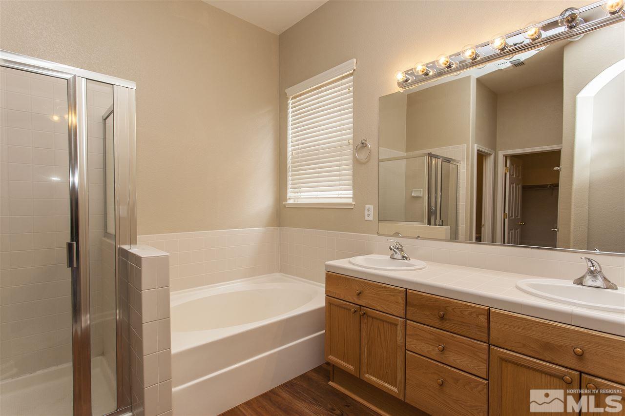 10430 Arbor Way Reno, NV 89521 - Photo 17 of 25 a bathroom with a tub sink and mirror