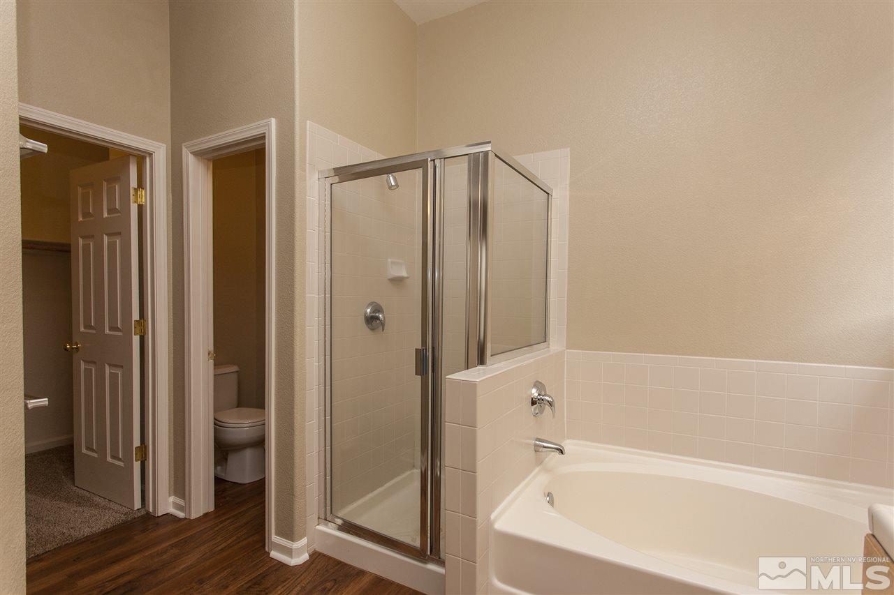 10430 Arbor Way Reno, NV 89521 - Photo 18 of 25 a bathroom with a bathtub and a shower
